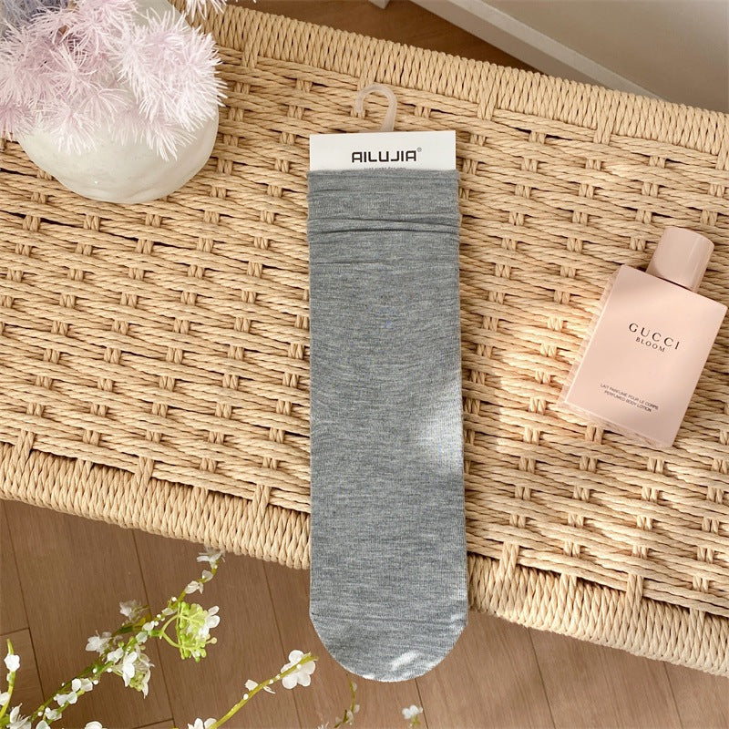 2025 spring and summer new college style classic solid color stacking socks breathable all-in-one machine boneless seam head medium tube women's socks